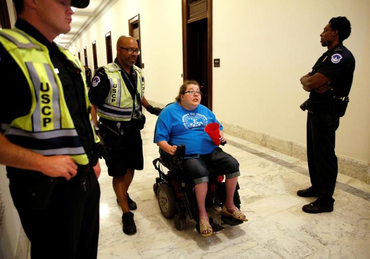 A protester demonstrating against the Senate health care bill outside Senate Majority Leader Mitch McConnell’s office / CNS photo
