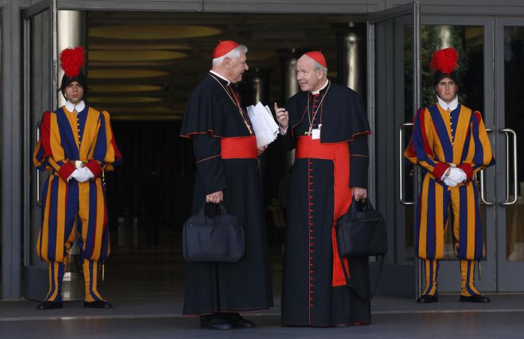 Cardinals Muller and Schonborn talk after morning synod session at Vatican