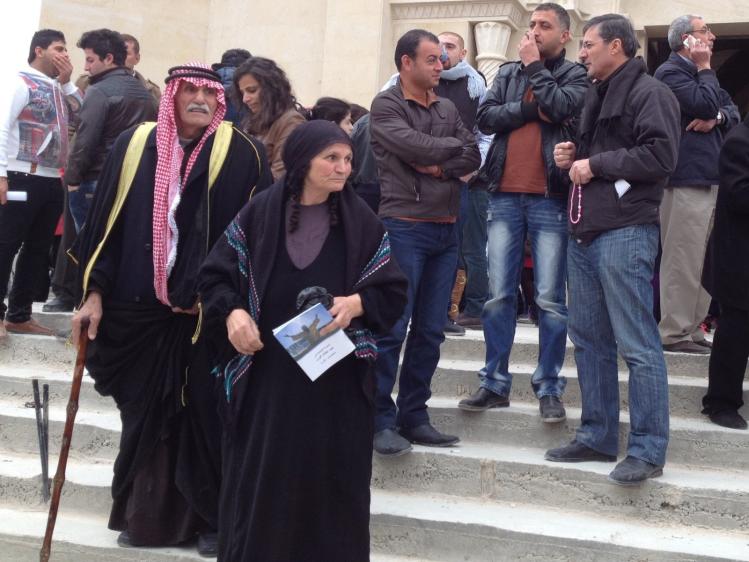 A Christian husband and wife, both wearing traditional Jordanian head scarves, after a Mass celebrated by the Latin Patriarch near the site of Jesus' baptism in the Jordan River.