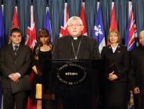 CNS/Art Babych:Cardinal Thomas Collins of Toronto speaks alongside other Canadian religious leaders